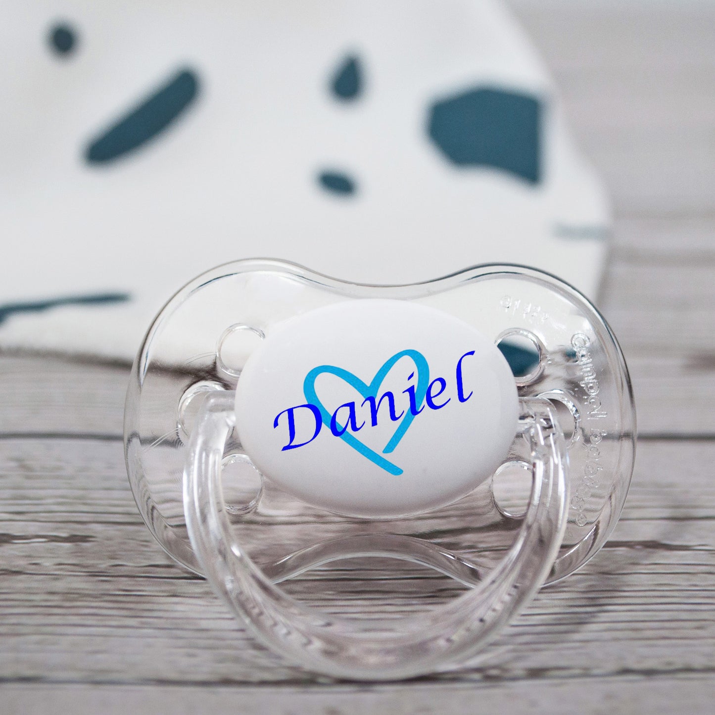 blue heart and name on transparent personalised baby dummy