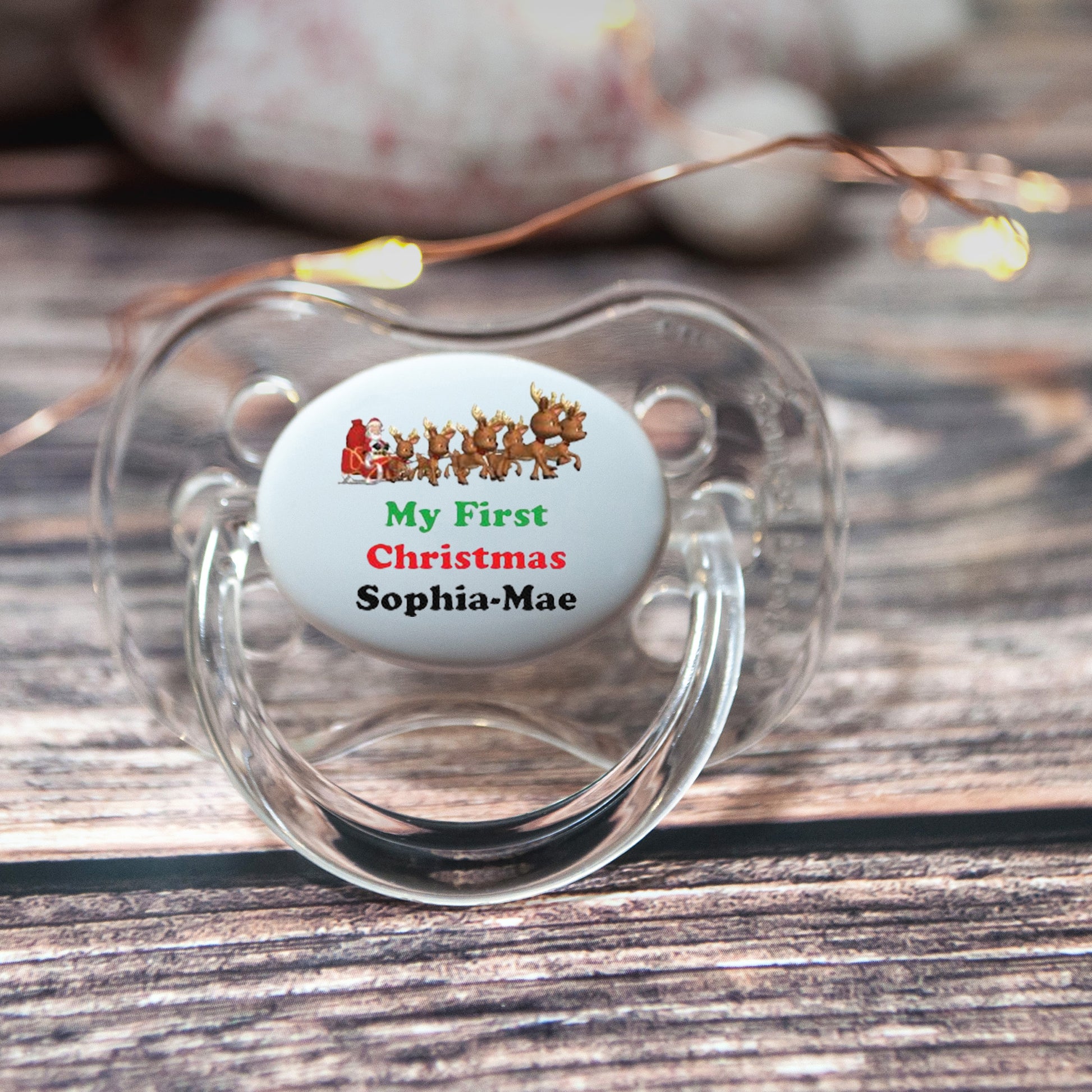 Personalised baby dummy with reindeers and baby's name.