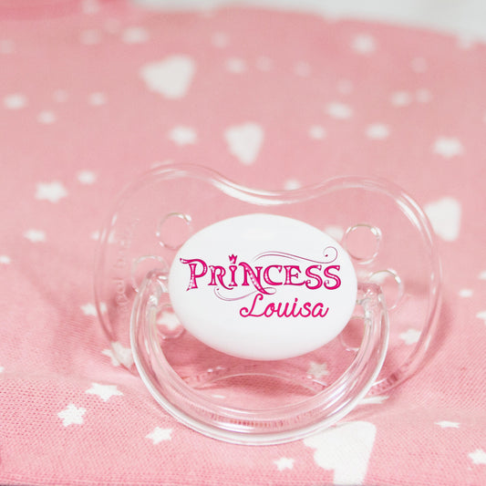 Personalised baby dummy with princess in fancy writing and name.